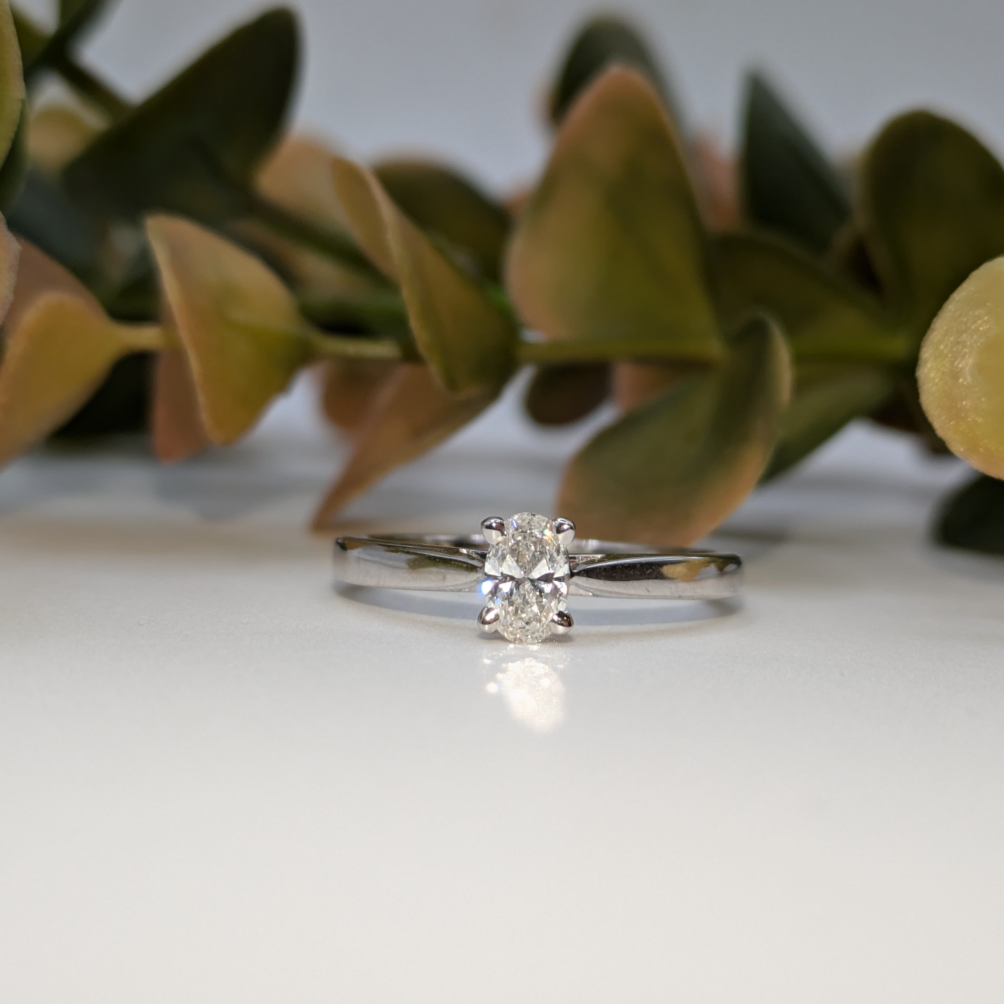Oval solitaire engagement with tapered shoulders