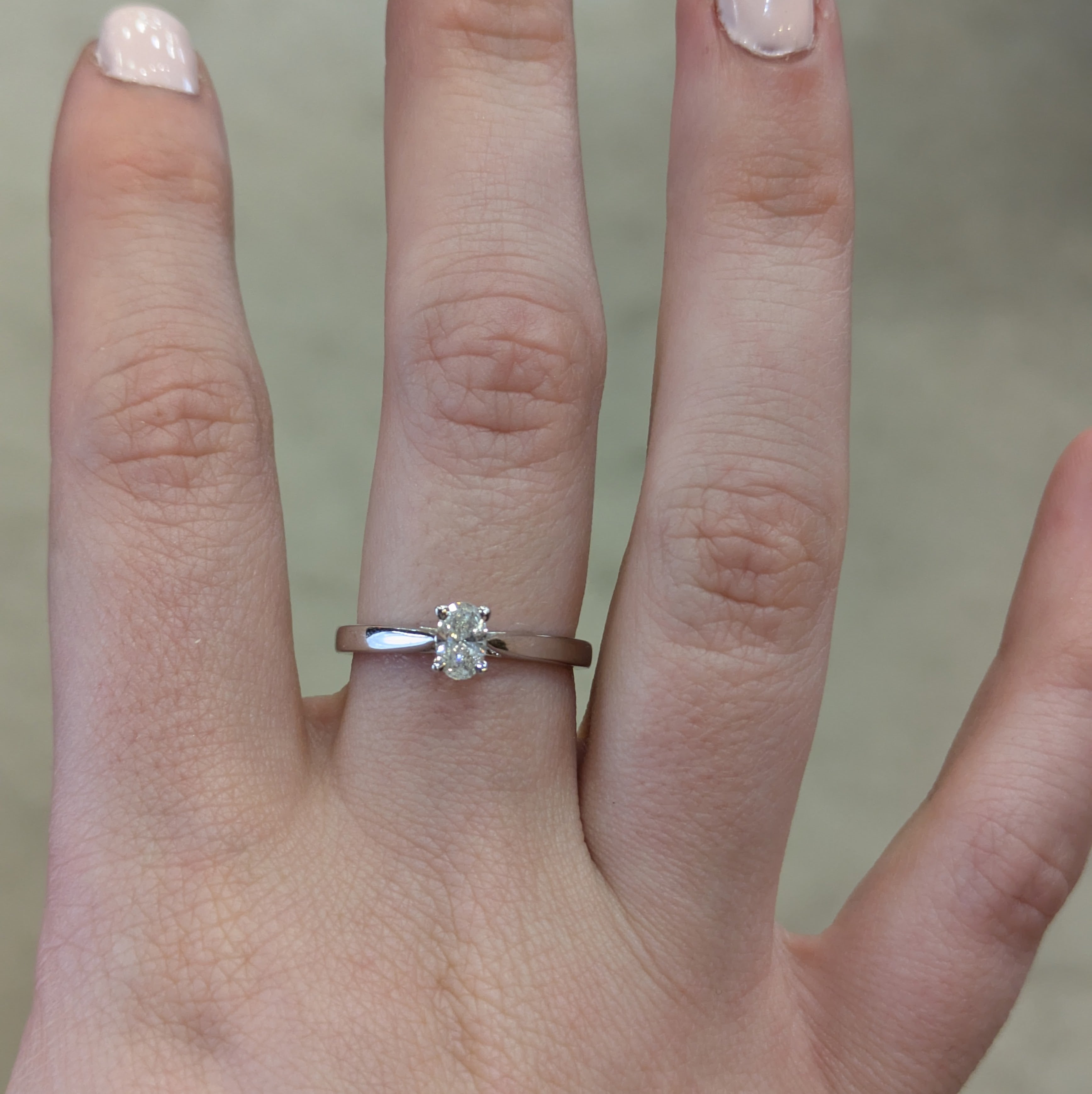 Oval solitaire engagement with tapered shoulders