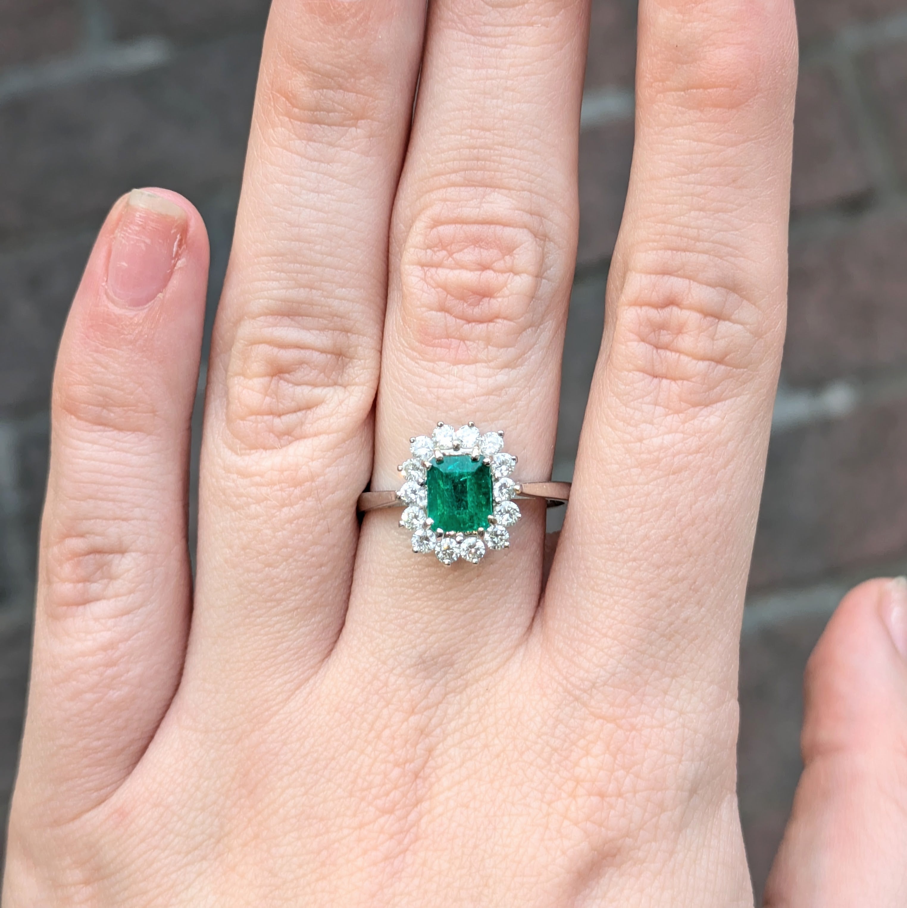 Emerald cut, emerald hem in diamond halo on 18k white gold ring
