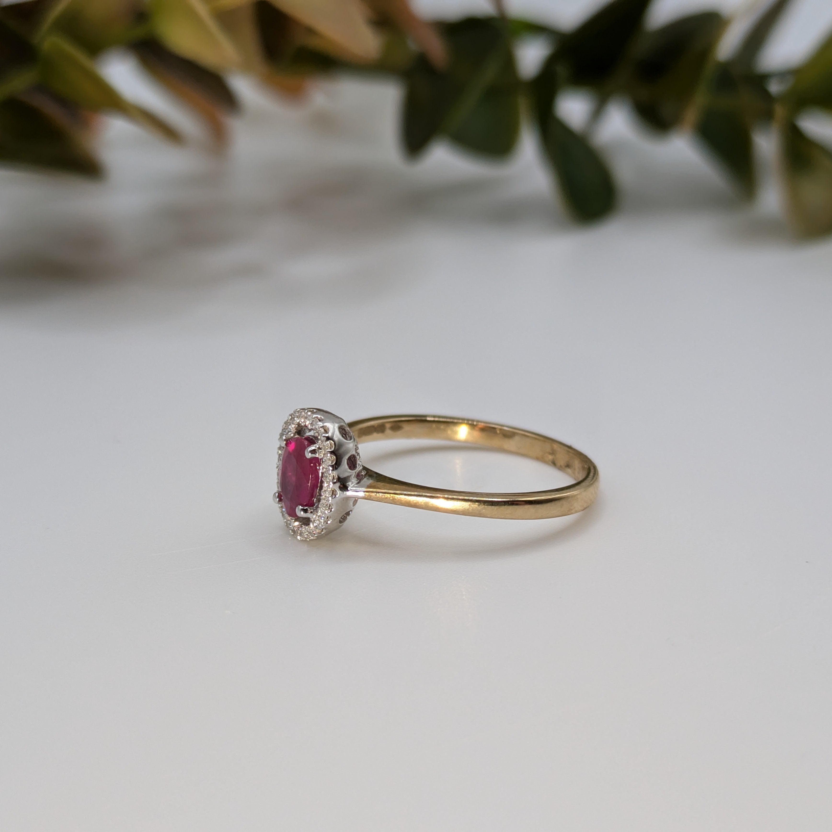 Oval ruby in diamond halo