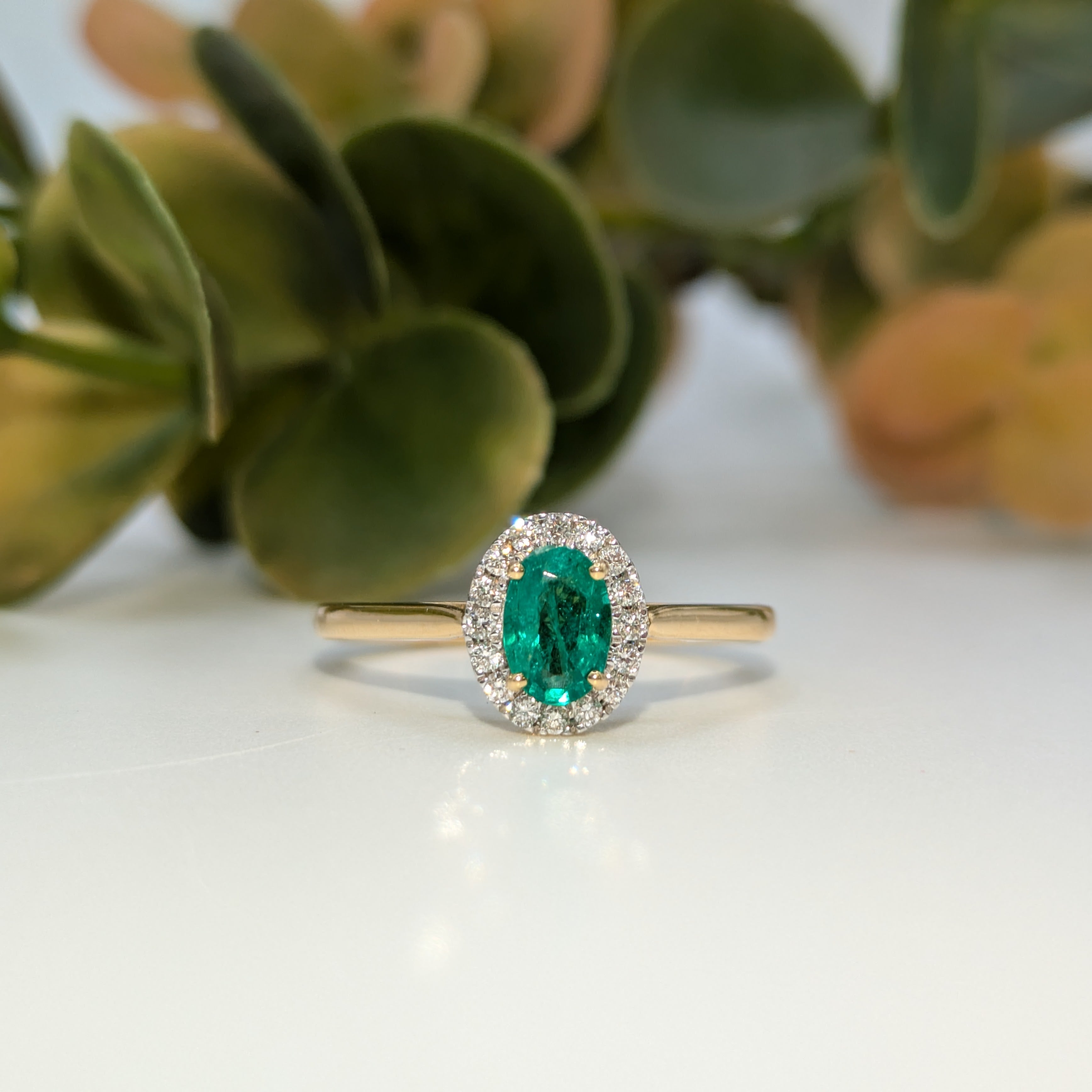 Emerald gemstone halo ring