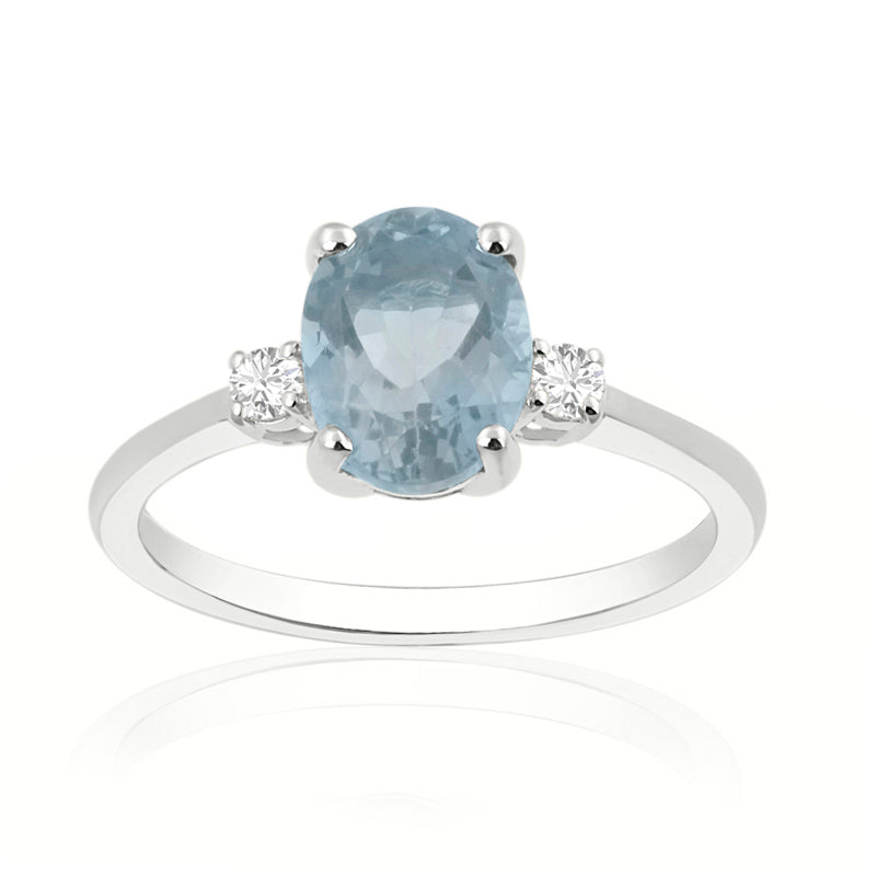 Oval aquamarine with round trilogy ring on 18k white gold